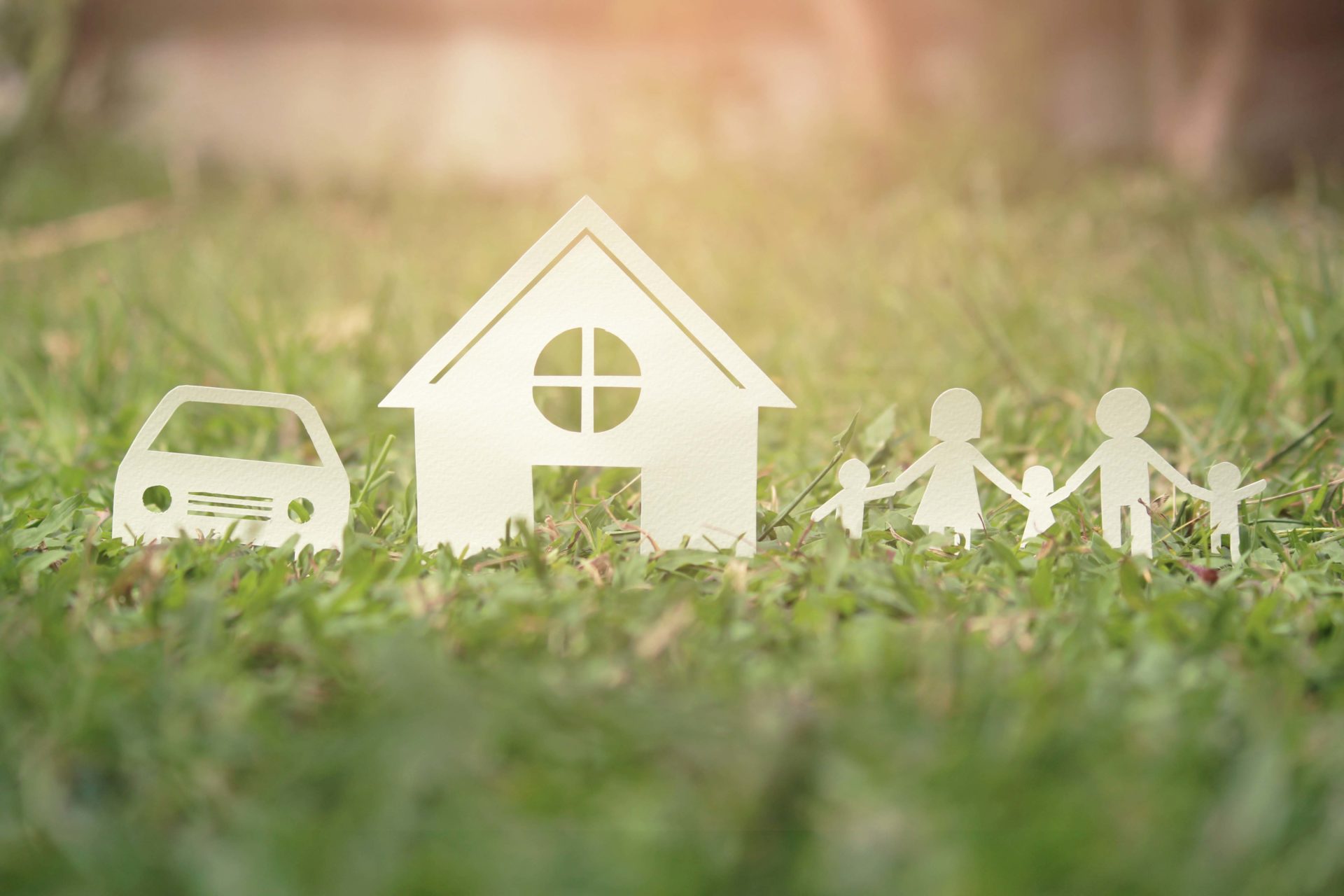 Paper cut of family on green grass, Concepts saving money for House and car, Vintage tone.