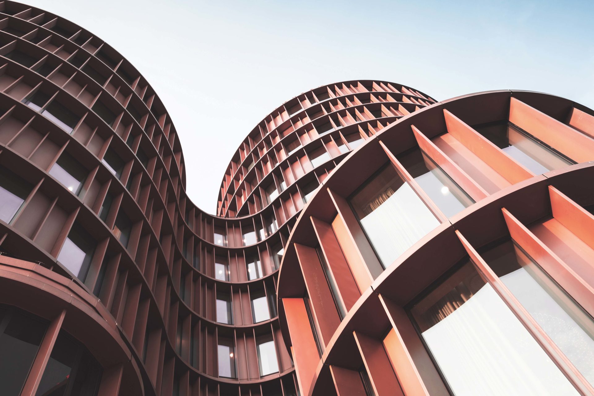 Abstract contemporary architecture background, round towers made of yellow shiny metal and glass