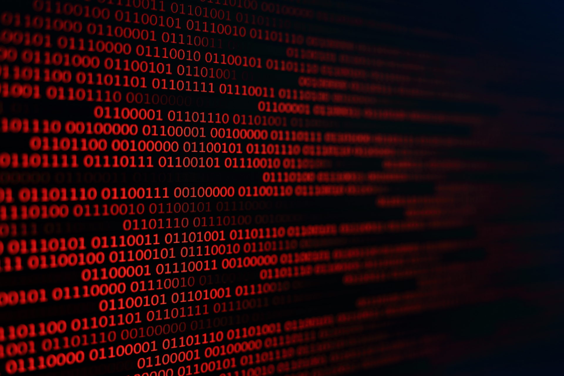 red binary code background. computer problems concept. black background. malware virus data transfer.