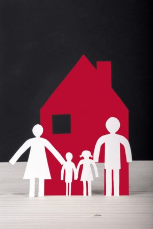 White Paper Chain Family with their House in front of a black Background